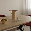 Glass Cups on Light Wooden Table with Kettle Bowl of Pears Red Chairs White Curtains