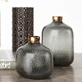 Gray Textured Vases With Gold Lids Green Foliage And White Flowers On Wooden Table