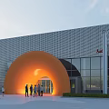 Modern Audi Showroom Building With Orange Arch Entrance Trees And People