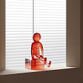 Red Transparent Human Figure Sculpture Sitting On Window Sill With White Blinds