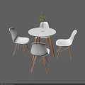 White Leisure Chairs With Wooden Legs Around Round Table And Green Plant