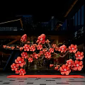 Vibrant Red Flower Floral Installation At Modern Building Entrance With Decorative Design
