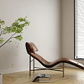 Brown Leather Lounge Chair With Metal Frame On Wooden Floor Near Green Plant