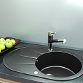 Black Oval Shaped Single Bowl Kitchen Sink With Black Faucet And Drainer Platform