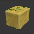 Yellow Cube Shaped Food With Green Herbs And Olive Topping On Textured Surface