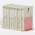 Organized Books with Pink Bookend and Spines Displaying Text Arrangement