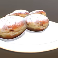 Four Fresh Golden Brown Donuts With Powdered Sugar On White Plate