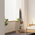 Wooden Coat Rack With Hanging Clothes Handbag Near Bedroom Bedside Table Lamp And Green Plant