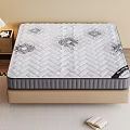 Comfortable Mattress With Patterned Surface On Bed Base Near Nightstand And Table Lamp