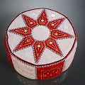 Round Decorative Cushion In Red And White With Star Pattern And Stitched Edges