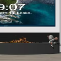 Modern Fireplace With Burning Flames And Small Decorative Figure Sitting On Edge