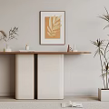 Modern Console Table Setup With Framed Golden Leaf Artwork And Tall Plant In White Pot