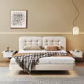 Double Bed With White Upholstered Headboard Plaid Blanket Beige Brown Pillows And White Nightstands