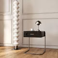 Black Nightstand with Drawer Silver Lamp and White Cup on Light Wainscoting Wall Wooden Floor