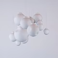 Multiple White Spherical Pendant Lights Hanging Against Light Colored Background 3d model