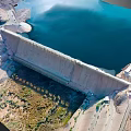 Scenic Aerial View Of Dam Landscape With Blue Water And Rocky Mountain Terrain