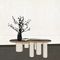 Round Light Wood Coffee Table With White Cylindrical Legs And Twigs In Vase