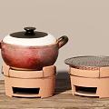 Traditional Clay Cooking Pot With Lid And Stand Alongside Mesh Covered Heating Tool