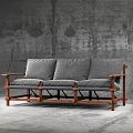 Gray Three Seat Leisure Chair With Wooden Frame And Gray Rough Wall Background