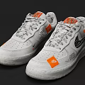 White Low Top Sneakers Featuring Orange Patches Black Designs And Gray Laces