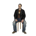Man sitting on chair wearing black leather jacket brown t-shirt ripped blue jeans gray shoes