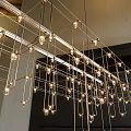 Modern Geometric Gold Metal Chandelier With Hanging Cube Grid And Illuminated Lights