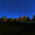 Scenic Autumn Landscape With Colorful Trees Lake Reflection And Distant City Buildings