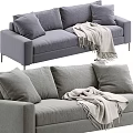 Gray Upholstered Two Seater Sofa With Soft Pillows And Knit Blanket