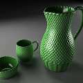 Green Honeycomb Textured Cup With Matching Pitcher And Bowl On Gray Table