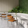 Modern Lounge Area Featuring White Curved Sofa Orange Chairs Round Tables and Green Plant Wall