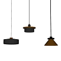 Five Black Pendant Lights with Various Shapes Hanging Some Illuminated Against White Wall
