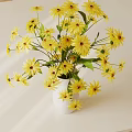 Yellow Flowers Arrangement In White Vase With Green Leaves On Light Background