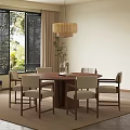 Round Wooden Dining Table With Beige Chairs Pendant Light And Green Plants Outside Window