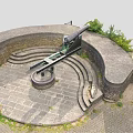 Historic Military Weapon Ancient Cannon on Circular Stone Platform With Stone Walls and Green Plants