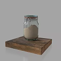 Glass Jar Containing Sand For Sculpture Carving On Wooden Base