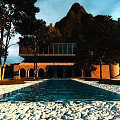 Mountain View Guesthouse Building With Modern Glass Balcony Traditional Arches And Tree Surroundings At Twilight