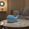 Whale Shaped White Decorative Lamp on Marble Coffee Table in Modern Living Room with Sofa