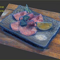 Sliced Raw Beef with Broccoli Lemon Slice and Salt on Black Plate Over Wooden Board