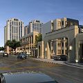 Modern Commercial Street Scene With Tall Buildings Cars Trees And Gateway