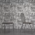 Stylish Leisure Chairs With Metal Frames And Wooden Seats Against Patterned Wallpaper