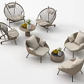 Rattan Outdoor Chairs With Soft Cushions And Round Table Decorated With Fruits And Flowers