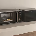 Two Sleek Black Microwave Ovens With Digital Display As Modern Kitchen Appliances