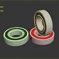 Household Bearings With Silver Blue And Red Rings Stacked On Surface