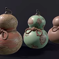 Three Gourd Shaped Sculptures With Carved Patterns And Knotted Rope Decorations