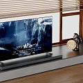 Modern Flat Screen Television On Stand With Waterfall Display And Decorative Items