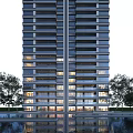 Modern High Rise Residential Building With Glass Facade Balconies And Surrounding Trees Water Feature