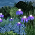 Purple Illuminated Outdoor Lights In Garden With Flower Shaped Design And Green Plants