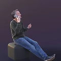 Man Sitting on Green Stool Talking on Phone Wearing Dark Sweater and Blue Jeans