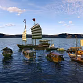 Traditional Wooden Boats Sailing On Calm Water With Multiple Sizes And Sails