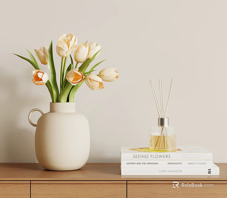 White Ceramic Vase With Cream And Orange Tulips Next To Reed Diffuser And Stacked Books 3d model 